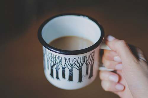 coffee cup white and black ceramic mug filled with coffee cup
